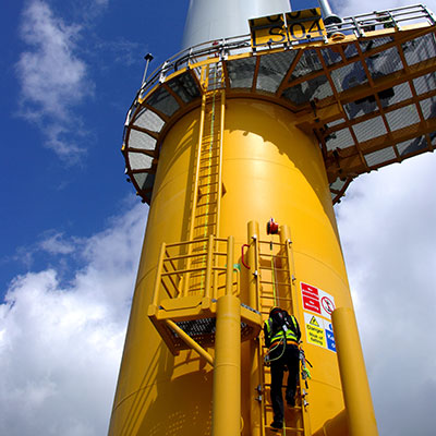 image of bottom of wind turbine with engineer